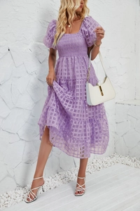 Detail of light purple checkered dress featuring puffed sleeves and layered A-line skirt