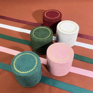 Top view of colorful velvet jewelry boxes with gold floral embroidery on lids