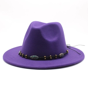 Detail of purple wool fedora with a black braided band and turquoise stone embellishments