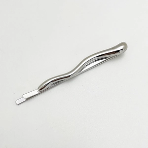 Close-up of wavy silver metal hair clip with a smooth polished finish on white background