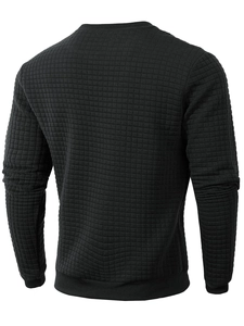 Rear view of black waffle knit sweatshirt featuring textured square pattern fabric