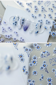 Detailed macro view of 3D embossed blue daisy nail stickers and finished floral manicure