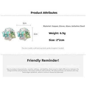 Detailed view of 18k gold plated butterfly cluster earrings with teal crystals and pearls