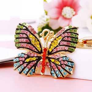 Detailed close-up of butterfly keychain with colorful rhinestones on gold metal base