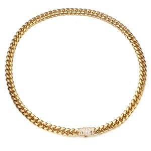 Close-up of golden Cuban link necklace featuring a sparkling diamond-encrusted buckle clasp
