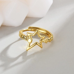 Irregular 14K gold-plated open star ring with chain and ridge textures on white background