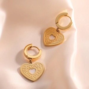 Elegant gold-plated heart pendant hoop earrings with LOVE engraving on silk background