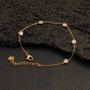 Detail of gold-plated stainless steel bracelet featuring clear zircon stones and lobster clasp