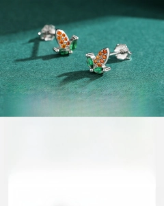 Detail of handcrafted S925 silver earrings with orange and green 5A zircon stones