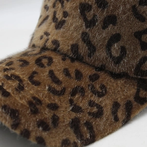 Close-up detail of plush faux fur baseball cap with brown and black leopard print