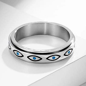 Macro shot of rotatable titanium steel ring with blue Evil Eye patterns and polished finish