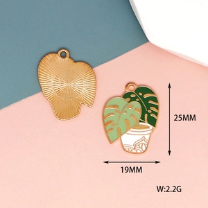 Detail of Monstera plant charm showing 25mm dimensions and green enamel finish
