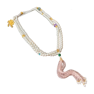Traditional flower pendant necklace with white pearls and a long tassel on white background