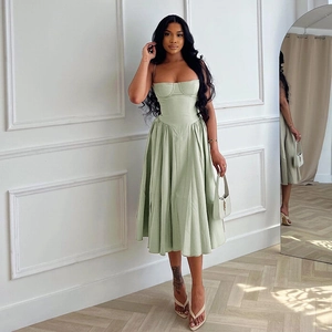 Detail view of light green ruched strapless midi dress with elegant pleated texture