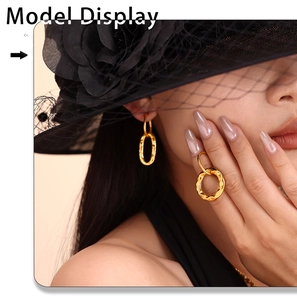 Close-up of model wearing gold geometric interlocking earrings and matching ring set