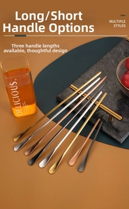 Set of stainless steel mixing spoons in gold, silver, and rose gold on a marble tray
