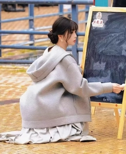 Detail of gray hooded oversized sweatshirt with drop shoulder and high-density fabric