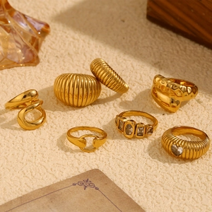 Macro shot of 7pcs gold plated stainless steel ring set with zircon and hammered texture