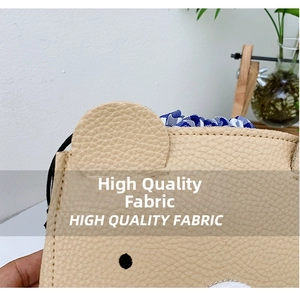 Detail of lychee pattern faux leather small bear bag with blue checkered fabric lining