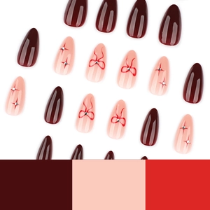 Red almond press on nails with silver star rhinestones and elegant bow designs