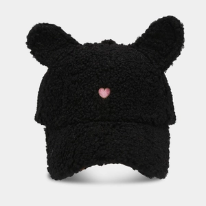 Close-up of black fuzzy plush hat with cute ears and pink heart embroidery detail