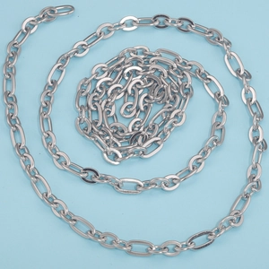 Polished silver stainless steel NK Cuban curb chain on a vibrant blue background