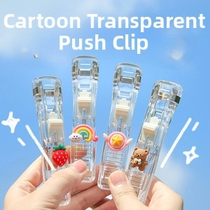 Close-up of four transparent push clip staplers with cute cartoon charms against a blue sky