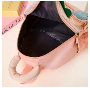 Detail view of pink kid backpack showing spacious grey interior and durable zipper closure