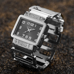 Macro view of silver square quartz watch featuring rhinestone-set hollow metal band