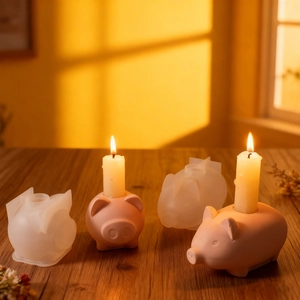 Macro detail of pig-shaped silicone molds and pink resin candle holder bases on wood