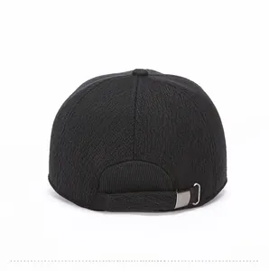 Rear view of black thermal winter cap showing textured fabric and metal buckle adjustment