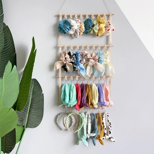 Vertical wall-mounted wooden hair accessory organizer with metal hooks for bows and headbands