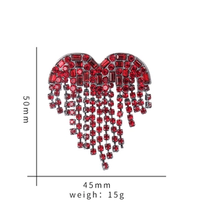 Detailed view of red rhinestone heart brooch with tassels showing dimensions 50mm x 45mm