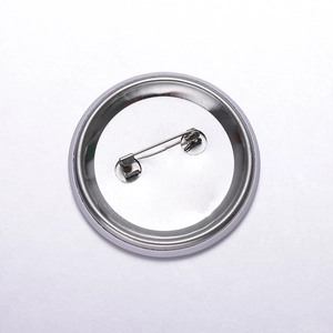 Macro view of round metal pin brooch back with secure silver safety pin fastener