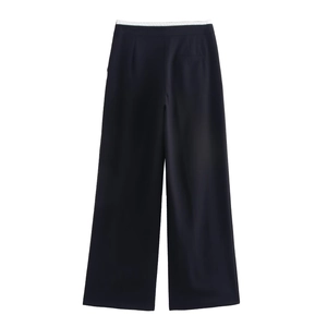 Detail of black wide-leg trousers featuring a white elastic double-waistband design
