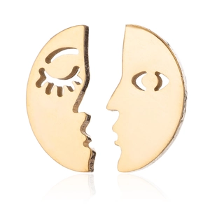 Detailed view of asymmetric gold face earrings with abstract hollow moon design features