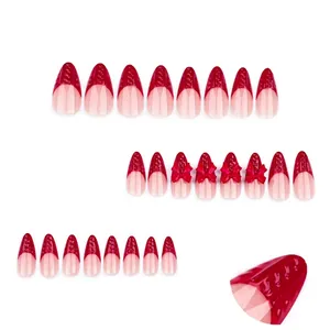 Red French press-on nails with 3D texture, bow accents and almond shape styling