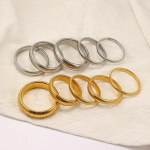 Detailed view of elastic titanium steel bracelets in gold and silver with various widths