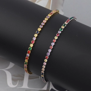 Detailed macro view of rainbow tennis bracelets in gold and silver with colored zircon stones