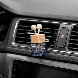 Square glass car perfume bottle with wood cap on air vent for aromatherapy