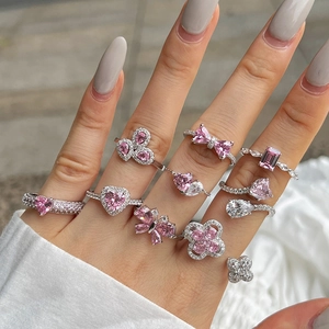 S925 silver rings with pink heart and butterfly stones shown on hand model