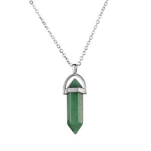 Macro shot of green translucent hexagonal crystal pendant with silver link chain