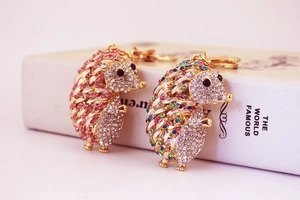Detail of two crystal-encrusted hedgehog keychains with pink and colorful rhinestones
