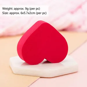 Rose red heart-shaped makeup sponge on a stone stand for wet and dry cosmetic use