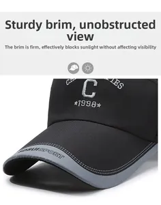 Detail of the structured brim and white letter embroidery on a black sports baseball cap