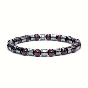 Detail of red garnet stone beads with silver metallic spacers on a handmade bracelet