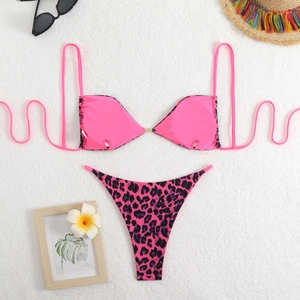 Pink leopard print two-piece bikini set with high-cut thong on white fur background