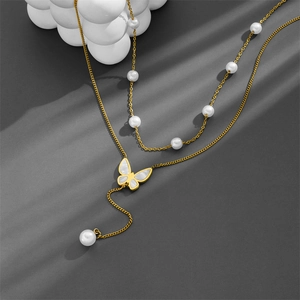 Double-layered gold titanium necklace featuring butterfly pendant and white pearl tassels