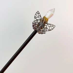 Handcrafted wooden hair pin featuring a hollow metal butterfly and iridescent crystal point