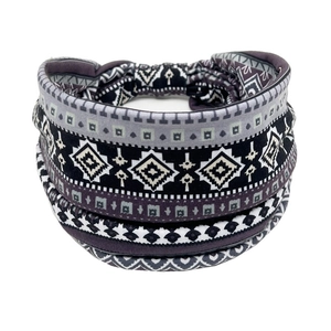 Detail of bohemian sweatband with grey and black geometric ethnic prints on elastic fabric